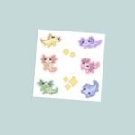 Kawaii pastel axolotl vinyl sticker sheet with six colourful axolotl characters in yellow lavender peach pink green and blue with gold star accents