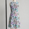 alice1-sleeveless-dress-bk1 Alice in Wonderland sleeveless dress with pastel pink and blue kawaii all-over print featuring Alice Cheshire Cat White Rabbit and Wonderland characters, flowy knee length front view on mannequin
