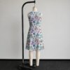 alice1-sleeveless-dress-bk2 Alice in Wonderland sleeveless dress with pastel pink and blue kawaii all-over print featuring Alice Cheshire Cat White Rabbit and Wonderland characters, flowy knee length front view on mannequin