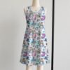 alice1-sleeveless-dress-fr1 Alice in Wonderland sleeveless dress with pastel pink and blue kawaii all-over print featuring Alice Cheshire Cat White Rabbit and Wonderland characters, flowy knee length front view on mannequin