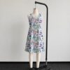 alice1-sleeveless-dress-fr2 Alice in Wonderland sleeveless dress with pastel pink and blue kawaii all-over print featuring Alice Cheshire Cat White Rabbit and Wonderland characters, flowy knee length front view on mannequin
