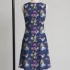 alice3-sleeveless-dress-bk1 Alice in Wonderland sleeveless dress with dark navy kawaii all-over print featuring Alice White Rabbit Cheshire Cat and Wonderland details, flowy knee length front view on mannequin