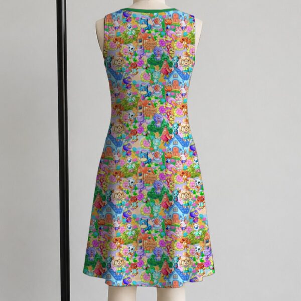 Animal Crossing sleeveless dress with all-over print of villagers Isabelle KK Slider and island characters in colourful print, flowy knee length front view on mannequin