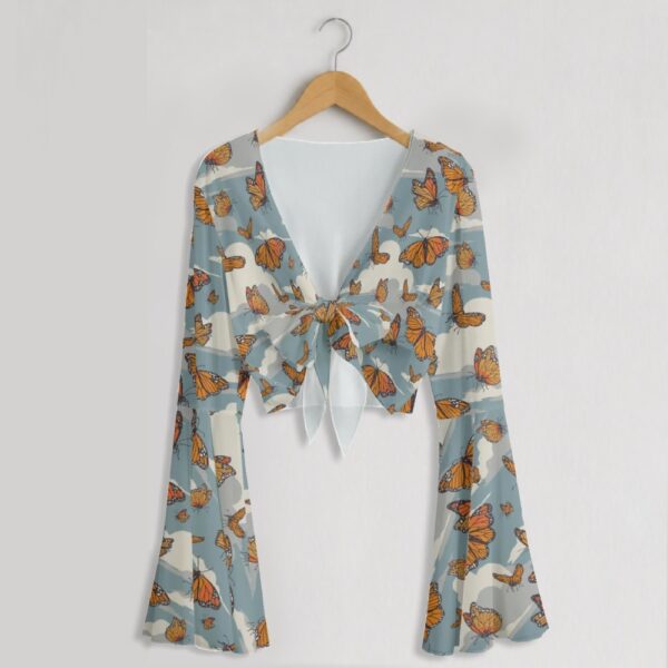 Monarch butterfly print mesh crop top with bell sleeves and tie front bow, all-over butterfly and cloud print on blue grey background, women's fit front view on hanger