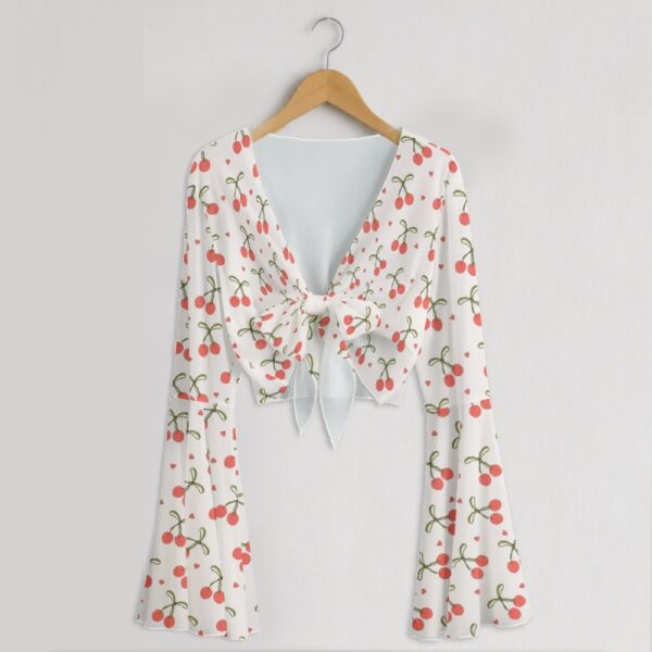 Cherry print mesh crop top with bell sleeves and tie front bow, all-over red cherry and heart print on white, women's fit front view on hanger