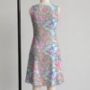 My Little Pony sleeveless dress with all-over retro G1 pony print in pastel pink blue purple and yellow, flowy knee length relaxed fit front view on mannequin