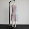 My Little Pony sleeveless dress with all-over retro G1 pony print in pastel pink blue purple and yellow, flowy knee length relaxed fit front view on mannequin