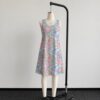 My Little Pony sleeveless dress with all-over retro G1 pony print in pastel pink blue purple and yellow, flowy knee length relaxed fit front view on mannequin