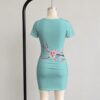 Cherry blossom bodycon dress mint green with pink floral sakura branches back view on mannequin