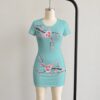 Cherry blossom bodycon dress in mint green with pink sakura floral print, short sleeve mini dress front view