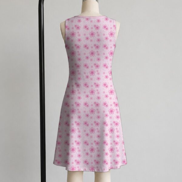 Pink sakura cherry blossom sleeveless dress with all-over pink floral print and sparkle details on pale pink background, flowy knee length front view on mannequin