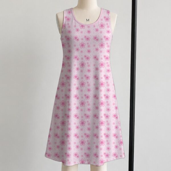 Pink sakura cherry blossom sleeveless dress with all-over pink floral print and sparkle details on pale pink background, flowy knee length front view on mannequin