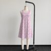 Pink sakura cherry blossom sleeveless dress with all-over pink floral print and sparkle details on pale pink background, flowy knee length front view on mannequin