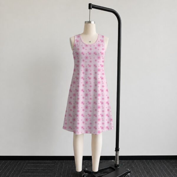 Pink sakura cherry blossom sleeveless dress with all-over pink floral print and sparkle details on pale pink background, flowy knee length front view on mannequin