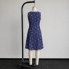 sleeveless-dress-dragonair-bk2 Dragonair Pokemon sleeveless dress with all-over print of Dragonair on deep navy background with white stars and pastel colour orbs, flowy knee length front view on mannequin