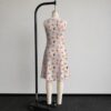 sleeveless-dress-eevees-bk2 Eeveelution Pokemon sleeveless dress with all-over kawaii print of Eevee Umbreon Espeon Sylveon Glaceon Vaporeon Jolteon and Flareon on soft pink background, flowy knee length front view on mannequin