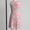 strawberry-daisy-sleeveless-dress-bk1 Pink strawberry daisy sleeveless dress with all-over print of strawberries daisies and butterflies on soft pink background, flowy knee length front view on mannequin