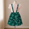 Teal green camo skirt overalls dress with adjustable straps and midi length skirt, all-over camouflage print
