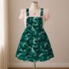 Teal green camo skirt overalls dress with adjustable straps and midi length skirt, all-over camouflage print