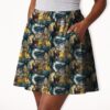 Studio Ghibli skater skirt with all-over print of Totoro Calcifer No Face Haku and Soot Sprites on rich teal background with side pockets worn by model