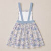 Haku dragon skirt overalls dress with all-over print of river spirit dragon in blue and lavender on cream background, adjustable straps