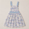 Haku dragon skirt overalls dress with all-over print of river spirit dragon in blue and lavender on cream background, adjustable straps