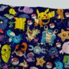 Pokemon skater skirt with all-over print of Pikachu Charmander Bulbasaur and Pokemon characters on navy galaxy background with side pockets