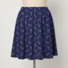 skirt-front-dragonair Dragonair Pokemon skater skirt with all-over print of Dragonair on deep navy background with white stars and pastel orbs, side pockets,