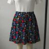 Dark navy skater skirt printed with Alice in Wonderland among red roses and deep side pockets