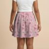 Pokemon skater skirt with all-over print of fairy type Pokemon with side pockets, worn by model