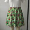 grinch-skirt2 Vibrant green skater skirt printed with Santa Grinch and featuring side pockets