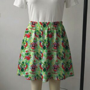 Vibrant green skater skirt printed with Santa Grinch and featuring side pockets