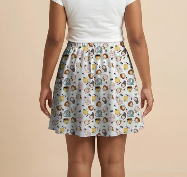 Studio Ghibli Spirited Away skater skirt with all-over print of Chihiro No Face Haku and Soot Sprites on rich teal background with side pockets worn by model